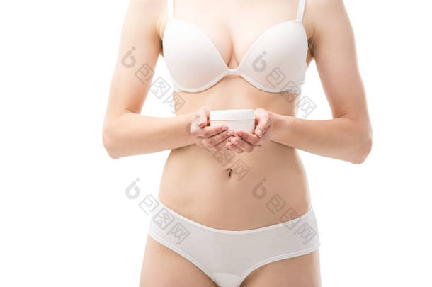 cropped view of young woman in underwear holding cosmetic cream isolated on white