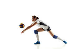 Young female volleyball player isolated on white studio background