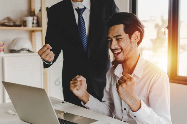 business man feeling excited with raised up hands expressing positive successful with young man empl