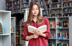 现代图书馆的年轻女子读书