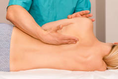 Woman having chiropractic back adjustment. Osteopathy, Alternative medicine, pain relief concept. Ph