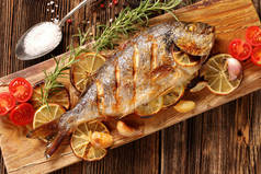 Roast Dorada on a wooden background