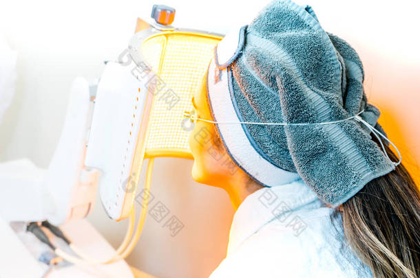 美容水疗患者正在接受Led光调制，用于基于光的面部，作为抗衰老治疗，以及防晒治疗.