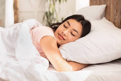 亚洲女人躺在床上抱着枕头睡觉