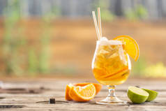 炎炎夏日，在花园的桌子上放着橙子和冰块的啤酒柠檬水