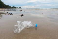 游客度假后，塑料瓶被留在海滩上。沙滩上的垃圾.