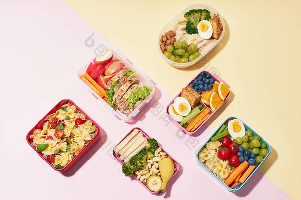 粉红背景的各类健康营养餐学校午餐盒的顶级观景模式