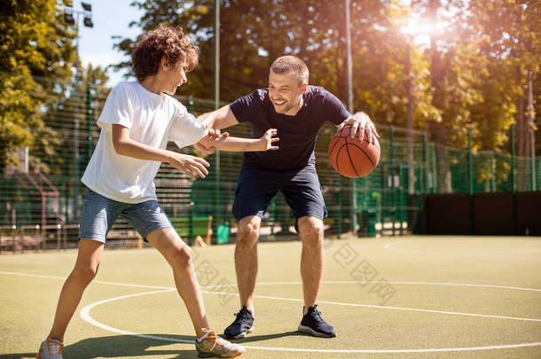 成熟男人教男孩打篮球