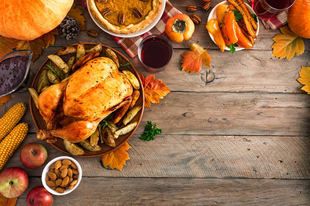 感恩节晚餐与鸡肉，覆盆子酱，南瓜派，葡萄酒，季节性蔬菜和水果在木制桌子上，复制空间。传统的秋节食品概念.
