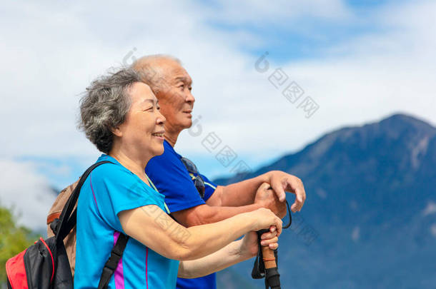 <strong>happy</strong> asian senior couple hiking in nature