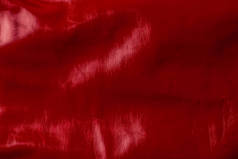 红色光泽的纺织品的上部看法作为背景