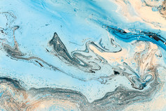 蓝色大理石质地。富有创意的背景与抽象油画手绘波浪的表面.液体油漆.