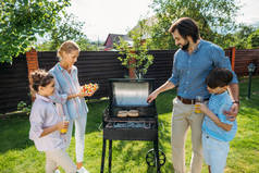 一家人一起在后院烧烤在夏天的一天