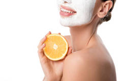 裁剪的妇女与面部皮肤护理面膜举行橙色孤立在白色