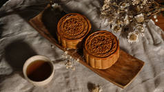 Moon cake for Mid autumn festival , Chinese traditional food and dessert decorating with dried flowe