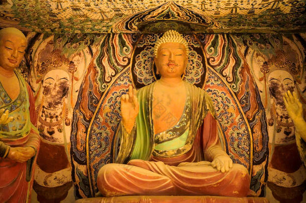 Apsaras mural and Bodhisattva sculpture in Dunhuang Mogao Grottoes, China