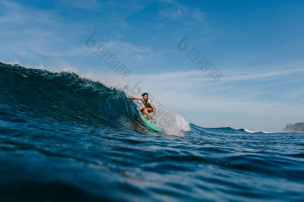 专业冲浪者在湿 t<strong>恤衫</strong>骑浪冲浪板上的阳光明媚的一天