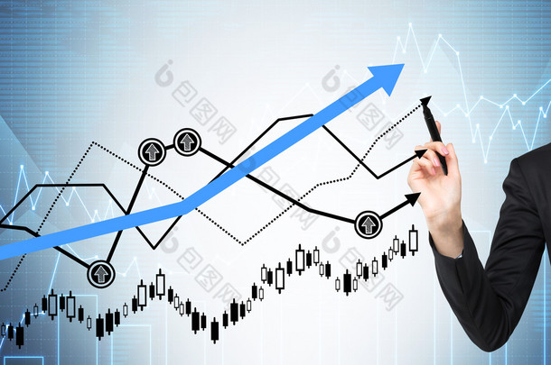 Woman's hand is drawing a growing graphs. Forex chart on the background.