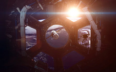 A round window on a space station with a view of Earth below. This image elements furnished by NASA