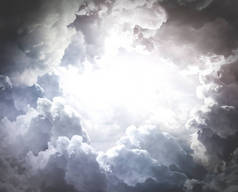 Beautiful background of cumulus clouds. A hole in the dramatic clouds. Copy space.