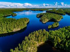 芬兰晴朗夏日的蓝湖和绿色森林鸟瞰图.