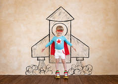 Superhero child having fun. Portrait of kid at home. Super hero kid playing. Funny rocket boy. Child