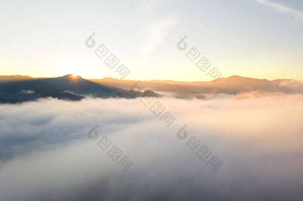 日出时,美丽的群山被蓬松的云彩覆盖在空中.无人机摄影