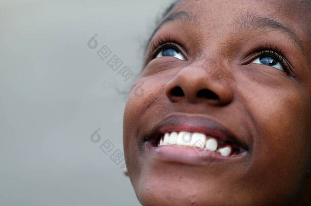 Happy black African teen girl opening eyes outside smiling