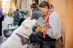 3.女人在户外咖啡馆吃意大利面的时候总是爱抚自己的狗