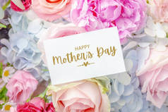 母亲节快乐卡片上有红花背景，粉红玫瑰和牡丹