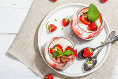 Italian dessert panna cotta in glass with strawberries. Healthy sweet food, trendy hard light, dark 