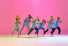 Happy children dancing. Group of children, little girls in sportive casual style clothes dancing in 