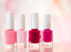 Shades of pink and red nail polish set on glamour background, nailpolish bottles for manicure and pe