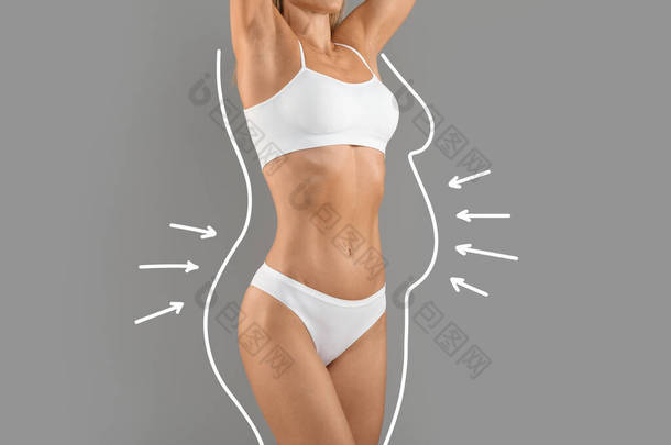 身体重组的概念。身穿白色内衣的女性，腰围拉长，身披弓箭，与灰蒙蒙的背景隔离，难以辨认的女性体重减轻的结果，结合部