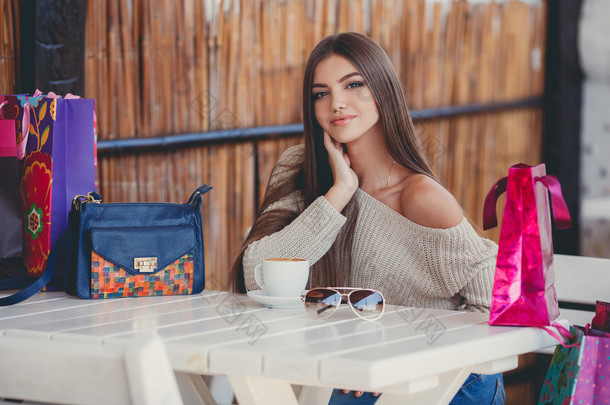 Charming woman in a cafe for a cup of coffee