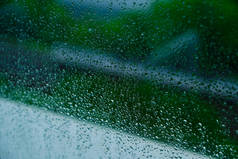 窗户上的云彩过后,水滴了下来.绿色背景.