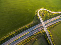 在有汽车的田野中的高速公路的空中景观