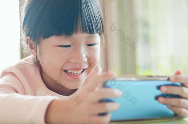 快乐的女孩观看视频或玩手机手机
