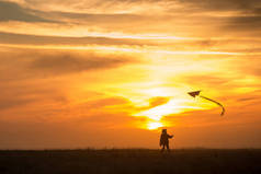 放风筝这个男孩带着风筝跑过田野。西尔胡