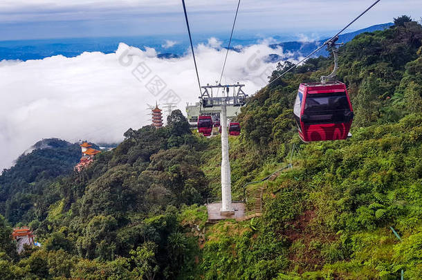 cable car at genting highlands, malaysia in a foggy weather with green grass visible from inside cab