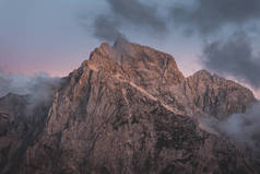 背景照片:高山山谷中的低云,生机勃勃的蓝色和橙色粉红的天空.日出或日落的景色,可以看到群山和山峰在云中的最高峰.斯洛文尼亚阿尔卑斯山脉冬季高山景观