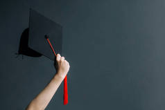 在白板上举起双手，戴上毕业帽。庆祝教育毕业生成功学习的理念
