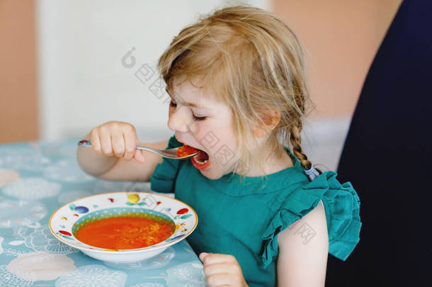 学龄前小女孩午餐吃健康的蔬菜汤.可爱快乐的孩子在家里或托儿所或幼儿园吃东西。新鲜蔬菜儿童的健康饮食.