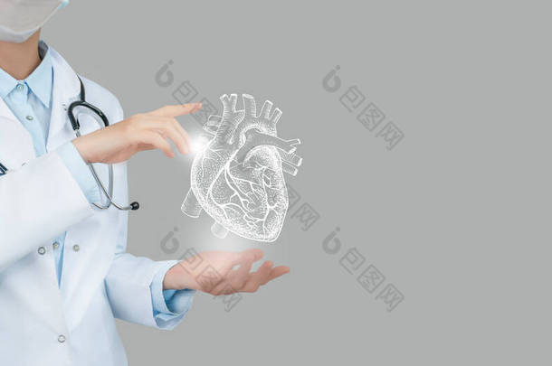女医生手握虚拟心脏。手绘<strong>人体器官</strong>，复制右边的空间，原始的照片颜色。保健医院服务概念库存照片