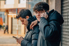 街上拿着手机或手机的年轻人