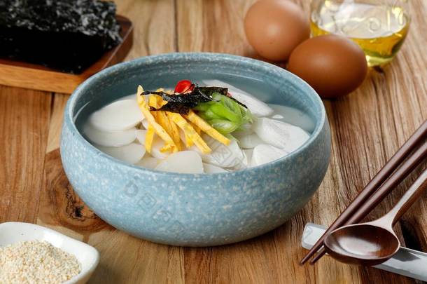 Tteokguk Korea Rice Cake Bar Soup for Seollal Year, top with Slice Egg, Chilli, and Sesame Seed