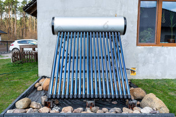 一种现代化的太阳能压力集热器，可加热家用热水，站在屋前草坪上.