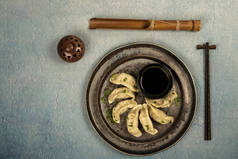 Gyoza or dumplings snack with soy sauce, selective focus, copy space.and chopsticks, top view.