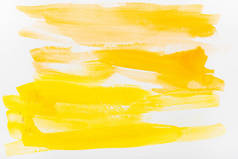 在白色背景上的黄色水彩笔触的顶部视图