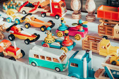 Wooden cars and other toys made by an artisan on the market. New eco materials for children and crea